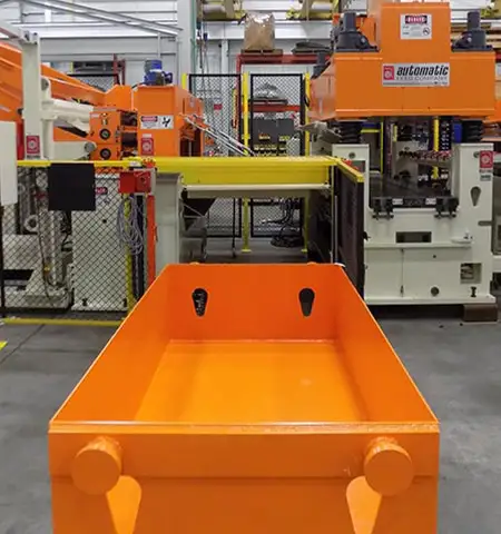 Industrial scrap handling system with collection bin in metal stamping facility